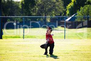 Baseball boy diving for ball.