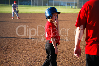Baseball boy looking at coach