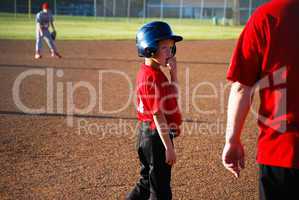 Baseball boy looking at coach
