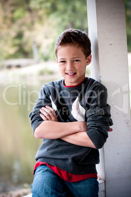 Portrait of young boy next to pole