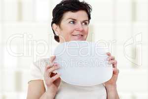 Woman with blank plate in his hand