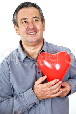 Elderly man holding red heart