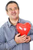 Elderly man holding red heart