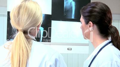 Female Doctors Viewing Patients X-Ray Results