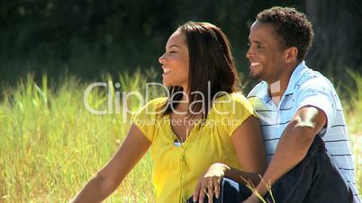 African American Couple Sitting in Park