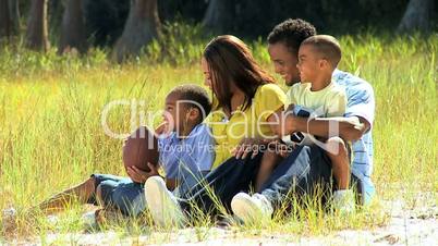 Young Ethnic Family Sitting in the Park