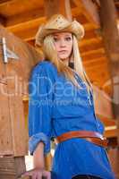 Blond Teen Model with Cowboy Hat in Wood Barn