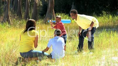 Ethnic Family Playing Baseball in Park