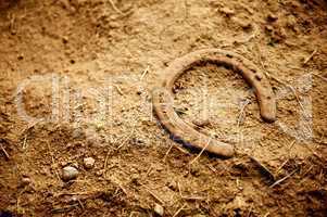 Rusty Old Horse Shoe Lying in Dirt