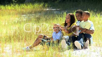 African American Family Sitting in the Park