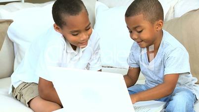 Cute Ethnic Brothers with Laptop Computer