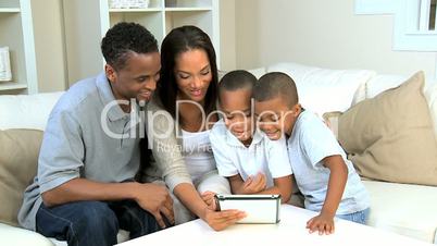 Young Family Using Wireless Tablet for Online Video Chat