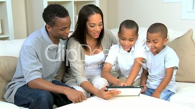 African American Family Using Wireless Tablet