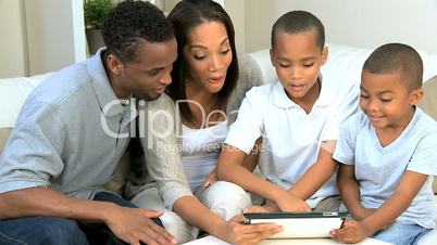 African American Family Using Wireless Tablet