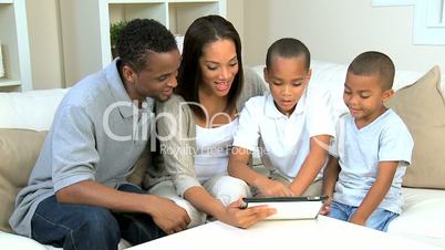 Young Family at Home Using a Wireless Tablet