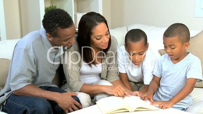 Parents and Little Ethnic Boys Reading a Book