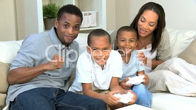 Ethnic Family Playing Handheld Electronic Gamea