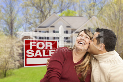 Couple in Front of For Sale Sign and House
