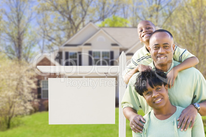 African American Family In Front of Blank Real Estate Sign and H