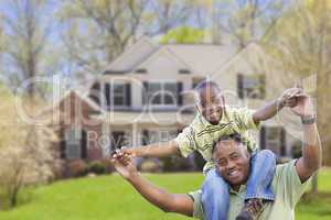 Playful African American Father and Son In Front of Home