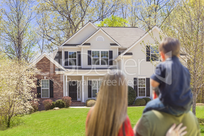 Mixed Race Young Family Looking At Beautiful Home