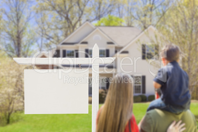 Family in Front of Blank Real Estate Sign and House