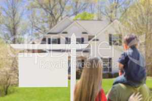 Family in Front of Blank Real Estate Sign and House