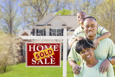 African American Family In Front of Sold Sign and House