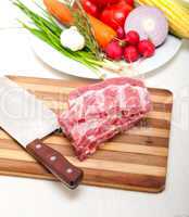 chopping fresh pork ribs and vegetables