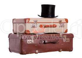 old suitcases with black hat