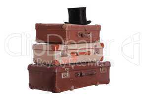 old hat on top of stacked suitcases