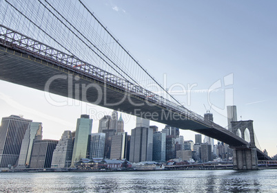 New York. Beautiful Brooklyn Bridge view from East River at suns