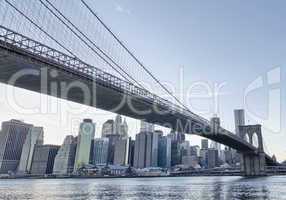 New York. Beautiful Brooklyn Bridge view from East River at suns