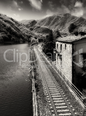 Railway with River, Sky and Vegetation in Tuscany