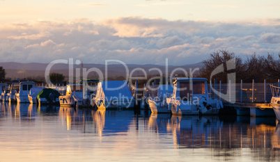 Boats in a marina at sunset