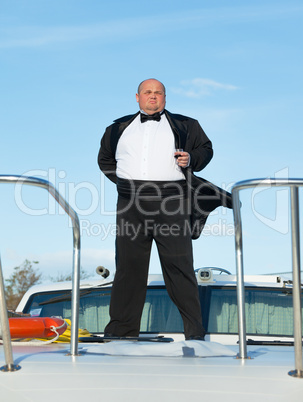 fat man in tuxedo with glass wine