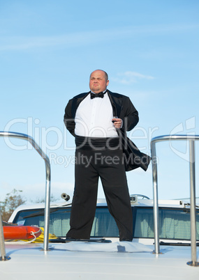 fat man in tuxedo with glass wine