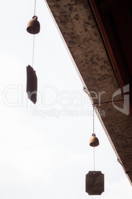 small wind bell hang on eaves with white background
