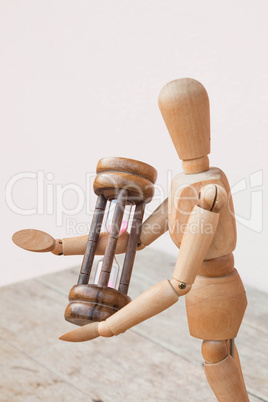 wood mannequin and hourglass display  time management