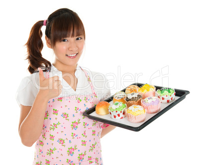 Thumb up Asian female baking