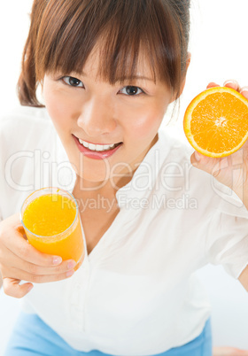 Asian girl drinking orange juice