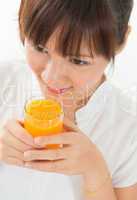 Asian female drinking orange