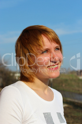 blue-eyed sympathetic girl looking at the sky