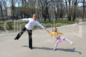 Mother with the daughter which dance in the city