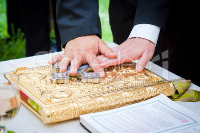 Hands on bible at a wedding ceremony