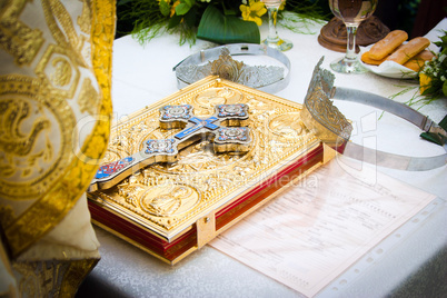 Wedding crowns and cross on a bible prepared for ceremony