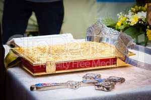 Wedding crowns, cross and bible prepared for ceremony