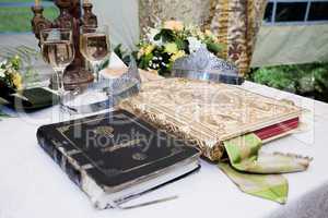 Wedding crowns, bible and wine glasses prepared for ceremony