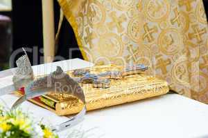 Wedding crowns and cross on a bible prepared for ceremony