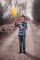 The cheerful boy with a balloon